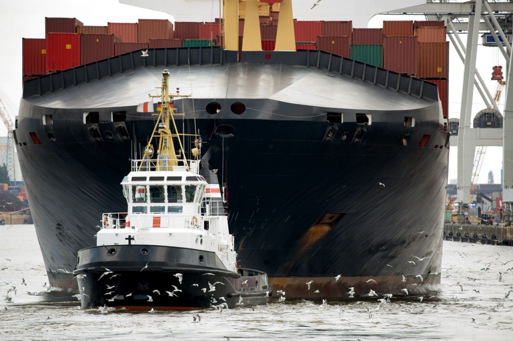 tugboat towing freighter in harbor – Decision Point Associates